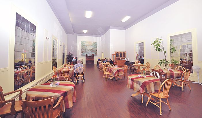 The full length of the dining room, with checked tablecloths