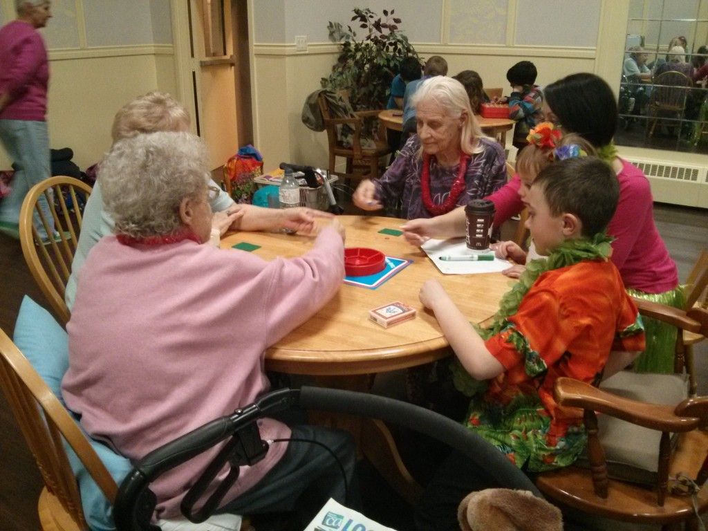Residents playing a table game together in the common room